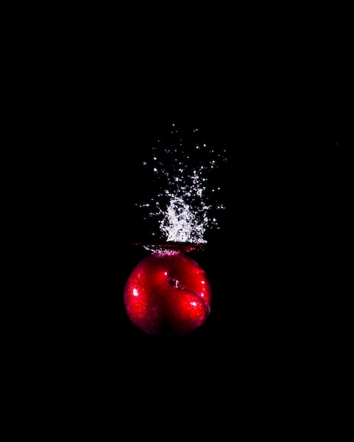 Free photo apple plunging into the water