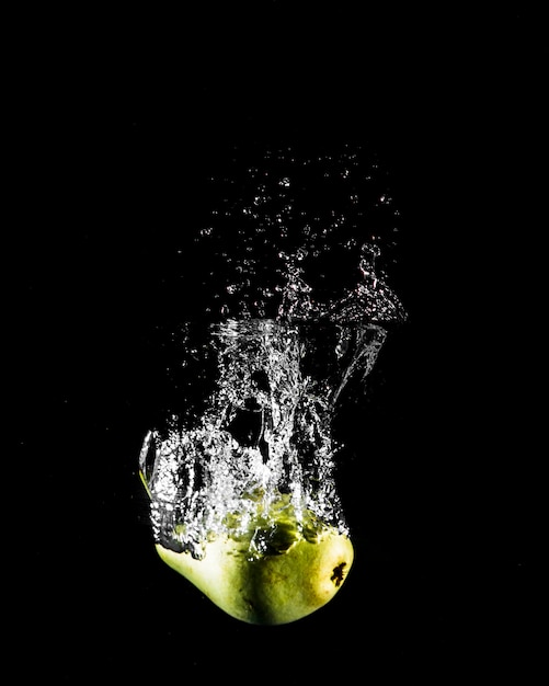 Free photo apple plunging into the water