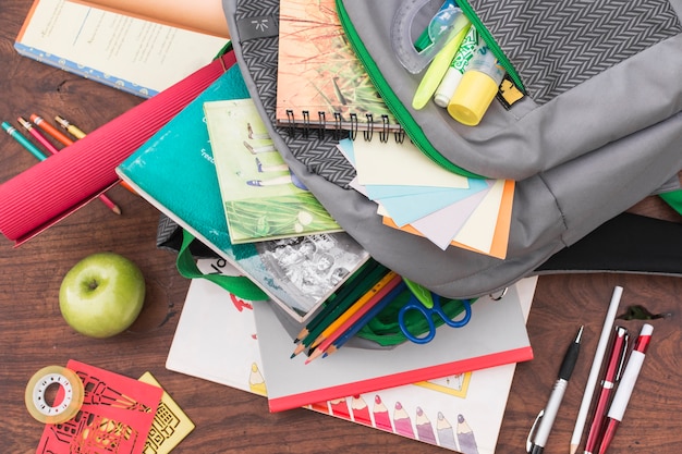 Free Photo apple and stationery near schoolbag