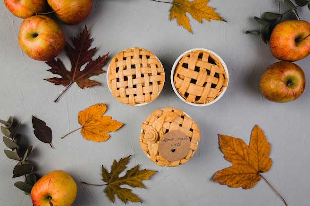 Apples and leaves around pies