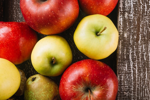 Free photo apples and pears near wooden plank