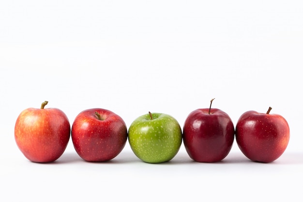 Apples red and green mellow juicy on a white desk