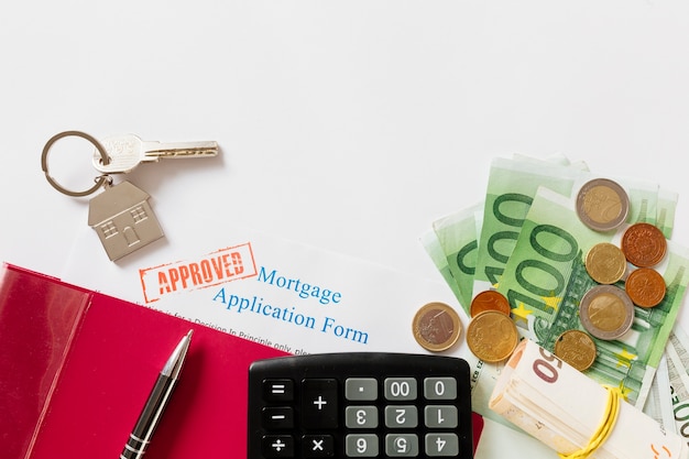 Approved mortgage contract and key with money