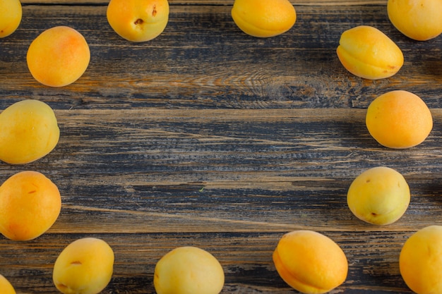 Apricots on a wooden table. top view.