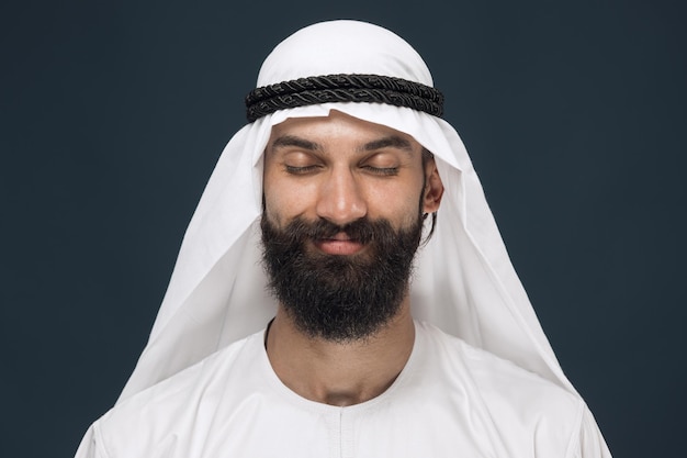 Arabian saudi man on dark blue studio background