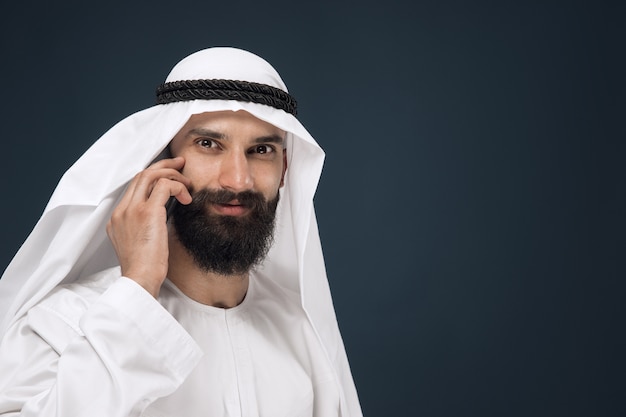 Free Photo arabian saudi man on dark blue studio