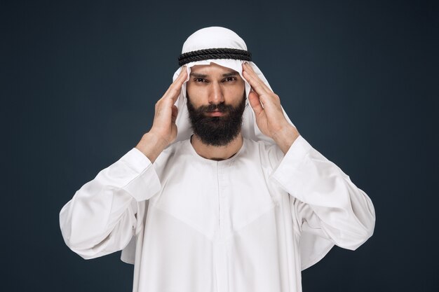 Arabian saudi man on dark blue studio