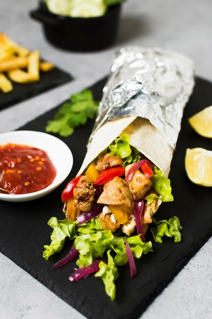 Free photo arabic kebab sandwich in aluminium foil