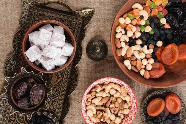 Free photo arabic ramadan lukum; dates; dried fruits and nuts on tabletop