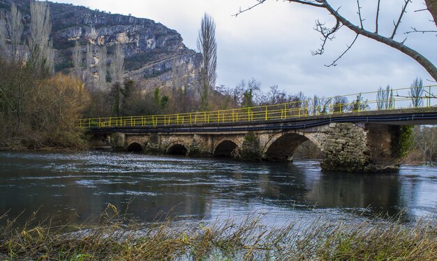 Arch bridge over the river surrounded by rocks in Krka National Park in Croatia