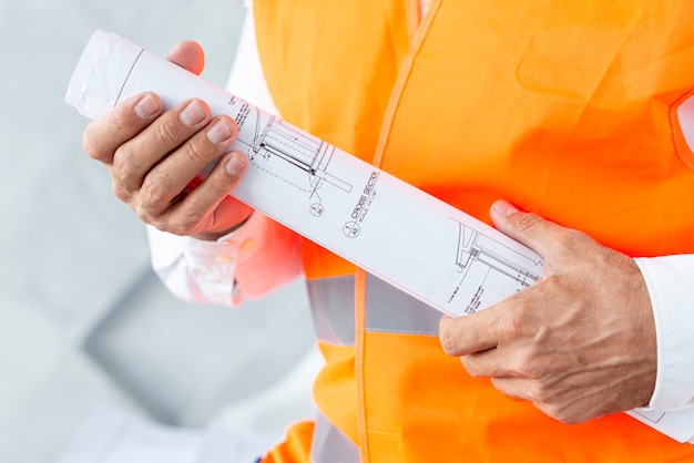 Architect holding plans close-up