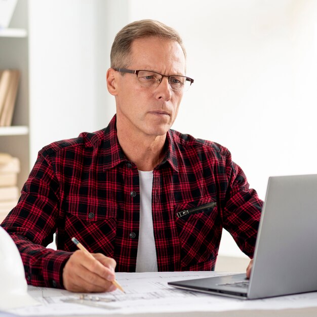 Architect searching for inspiration on laptop