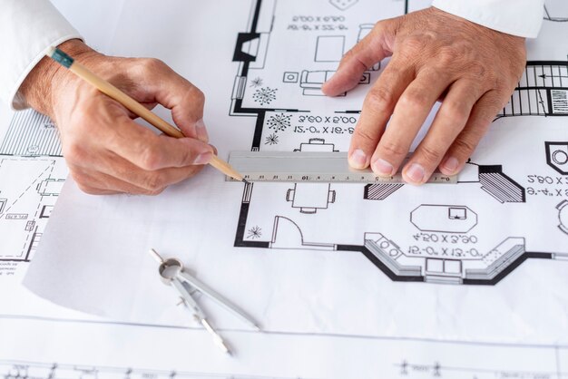 Architect using ruler on his project close-up