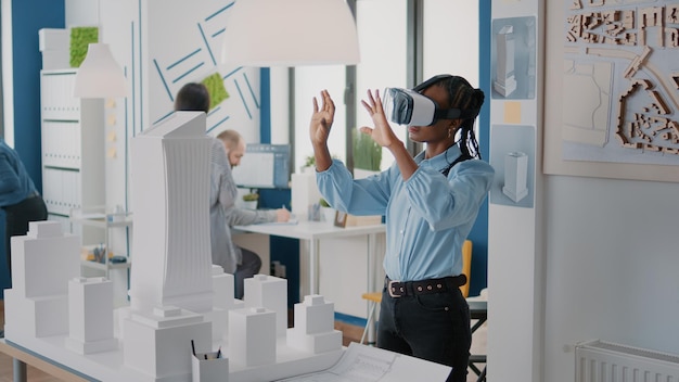 Free photo architect using vr glasses to design building model and construction layout. woman contractor working with virtual reality headset to plan real estate structure, creating urban project.