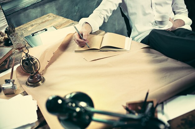 Architect working on drawing table in office