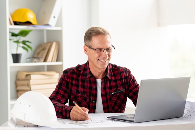 Architect working on laptop for his project