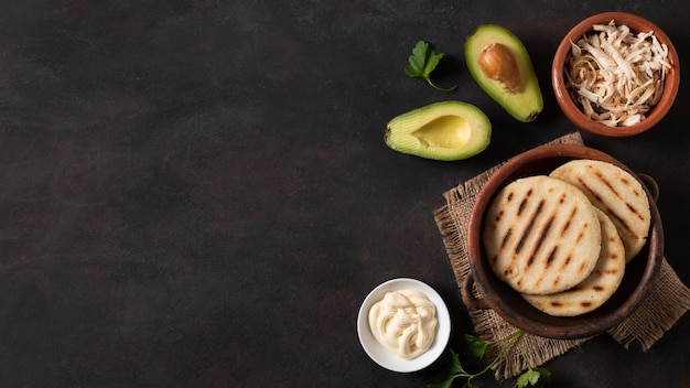 Arepas and avocado frame flat lay