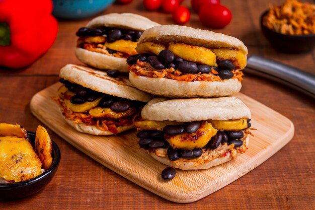 Arepas with delicious filling on chopping board