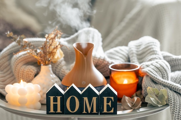 Free photo aroma composition with a modern aroma oil diffuser candles and a knitted element