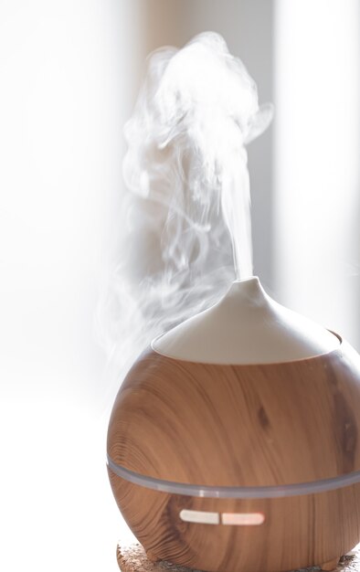 Aroma oil diffuser lamp on a table. Aromatherapy and health care concept.