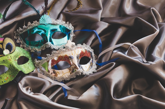 Arranged colorful masks on silk