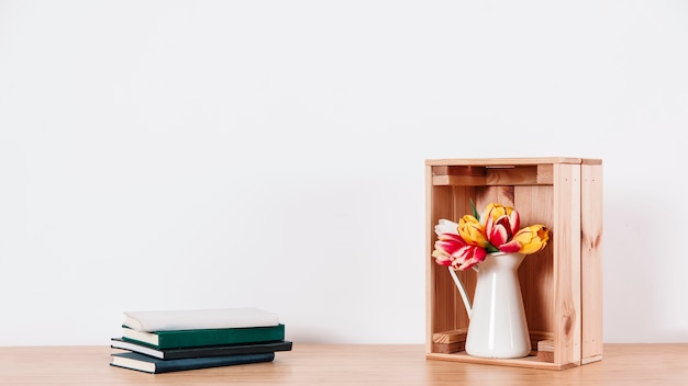 Arranged flowers in box and notebooks