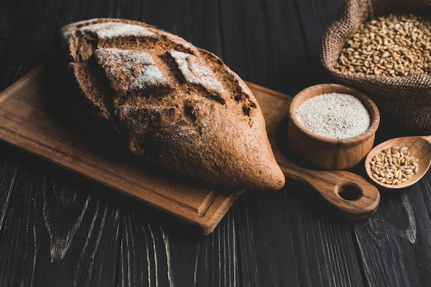 Free Photo arranged loaf of bread and grains