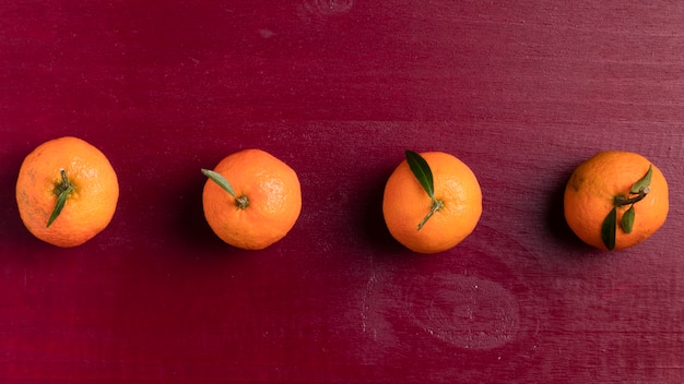 Free Photo arranged tangerine with red background for chinese new year