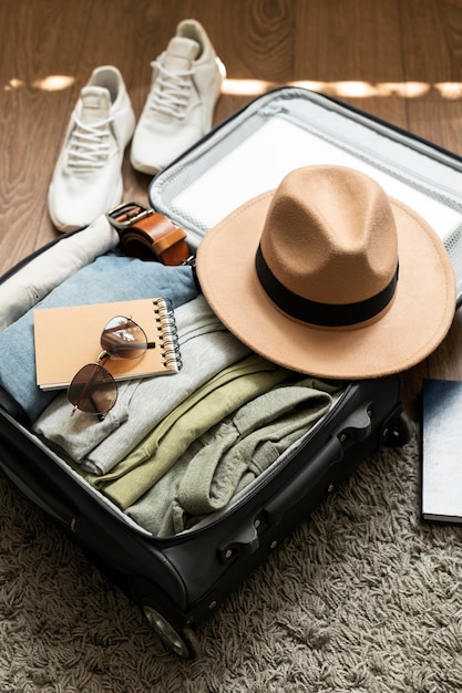 Free photo arrangement of clothes and accessories in a suitcase