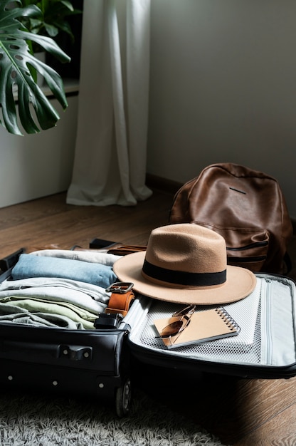 Free photo arrangement of clothes and accessories in a suitcase