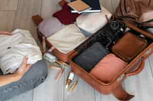 Free photo arrangement of clothes and accessories in a suitcase