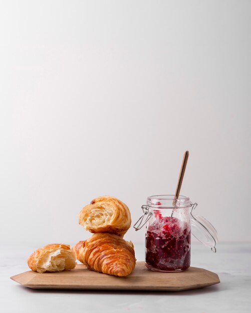 Arrangement of croissant and homemade wild berry jam