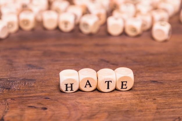 Free Photo arrangement of cubes with text hate on wooden table