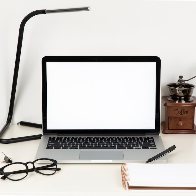 Arrangement of desk elements with empty laptop screen