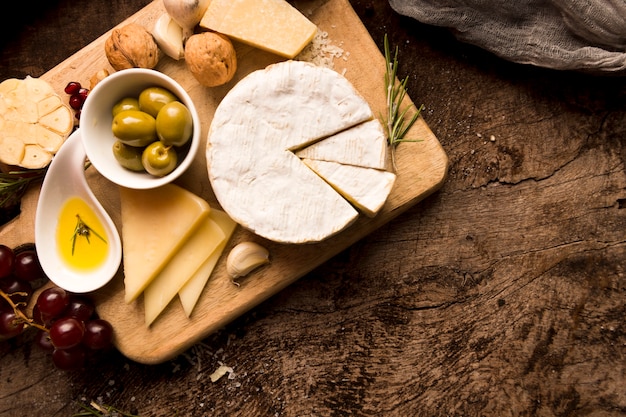 Arrangement of different delicacies on wooden table with copy space