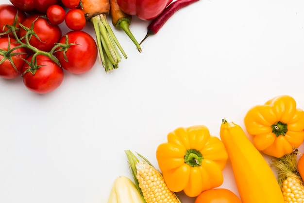 Arrangement of different warm colored vegetables with copy space