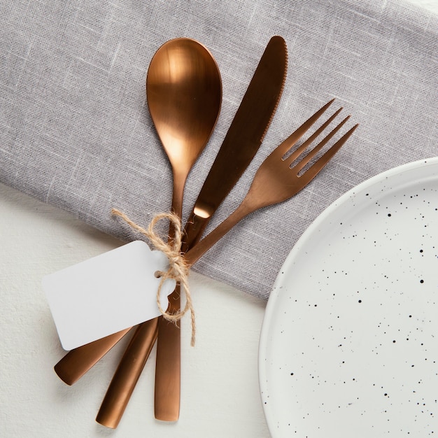 Arrangement of elegant tableware with empty tag