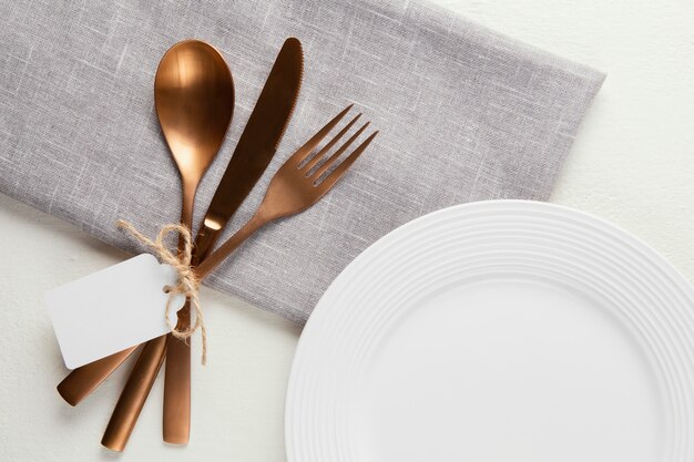 Arrangement of elegant tableware with empty tag