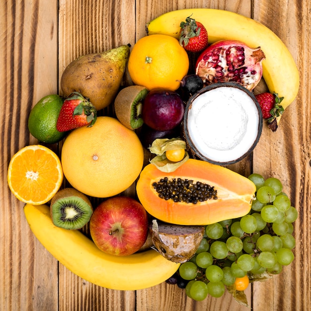 Free photo arrangement of exotic fruit on wooden background