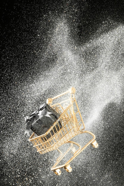 Arrangement of golden shopping cart with white glitter