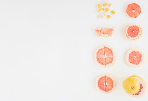 Arrangement of grapefruit cut into different slices isolated on white background