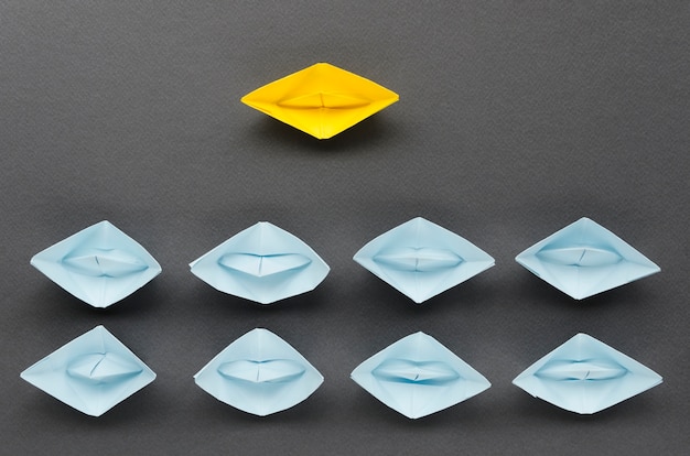 Free photo arrangement for individuality concept with paper boats on black background