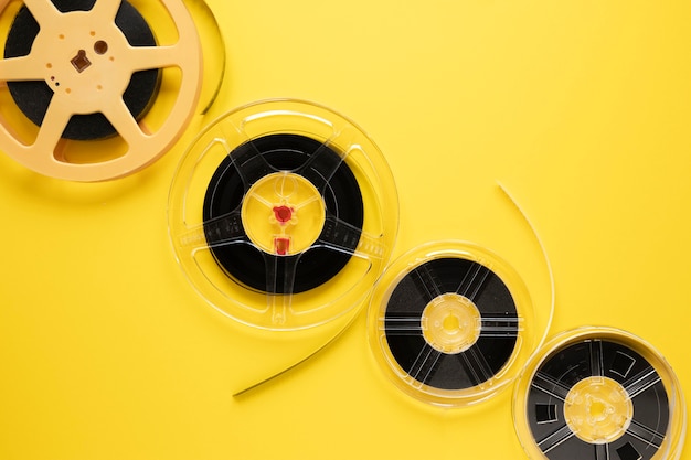 Free Photo arrangement of movie reels on yellow background