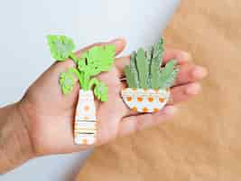 Free photo arrangement of paper plants held in hand