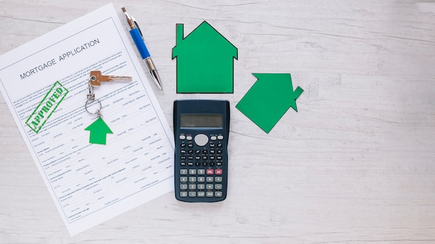 Free photo arrangement of papers and key on desk