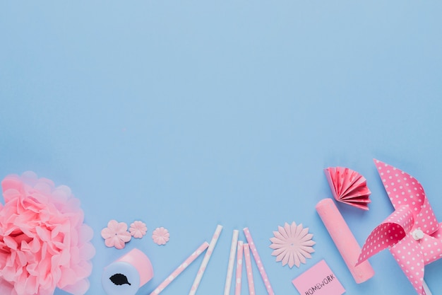 Arrangement of pink craft art and equipment on blue backdrop