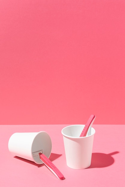 Free photo arrangement of pink razor blades and cup