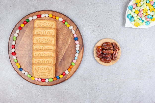 Arrangement of popcorn candy, dates and cookies on marble background. High quality photo