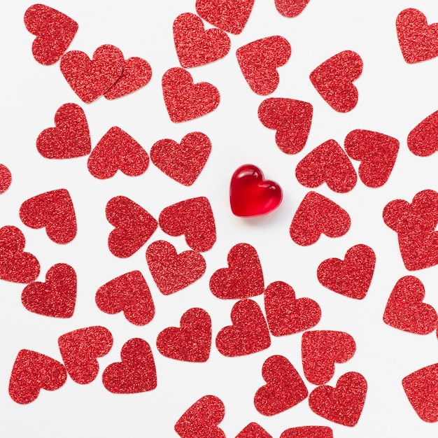 Arrangement of red hearts on white background