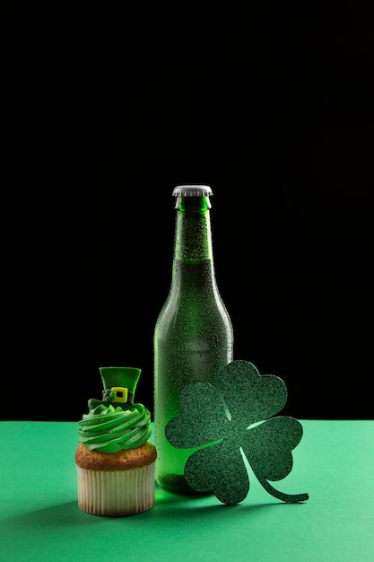 Free Photo arrangement with beer bottle, cupcake and clover